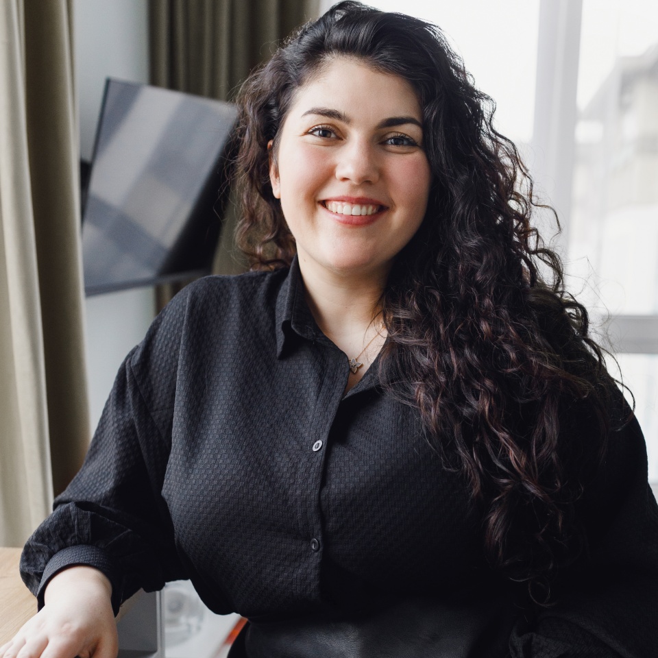 Vertical indoor portrait of smiling caucasian plus size female sitting at table in living-room, advertising remote education and freelance work online at home workplace. Small business or startup